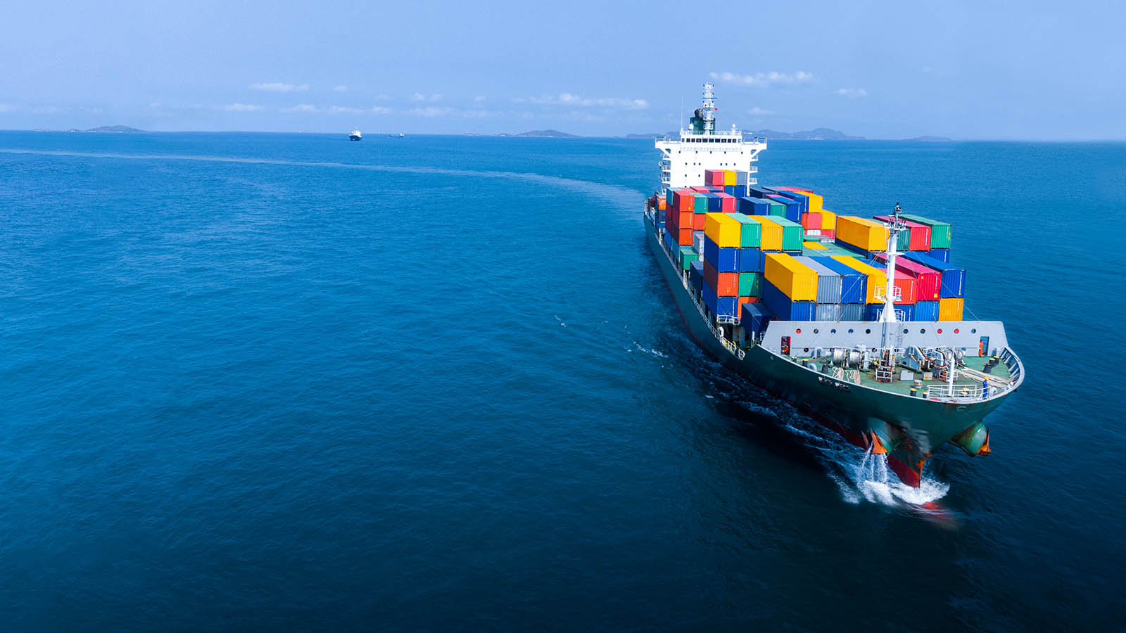 Container ship under way at sea, loaded with freight containers